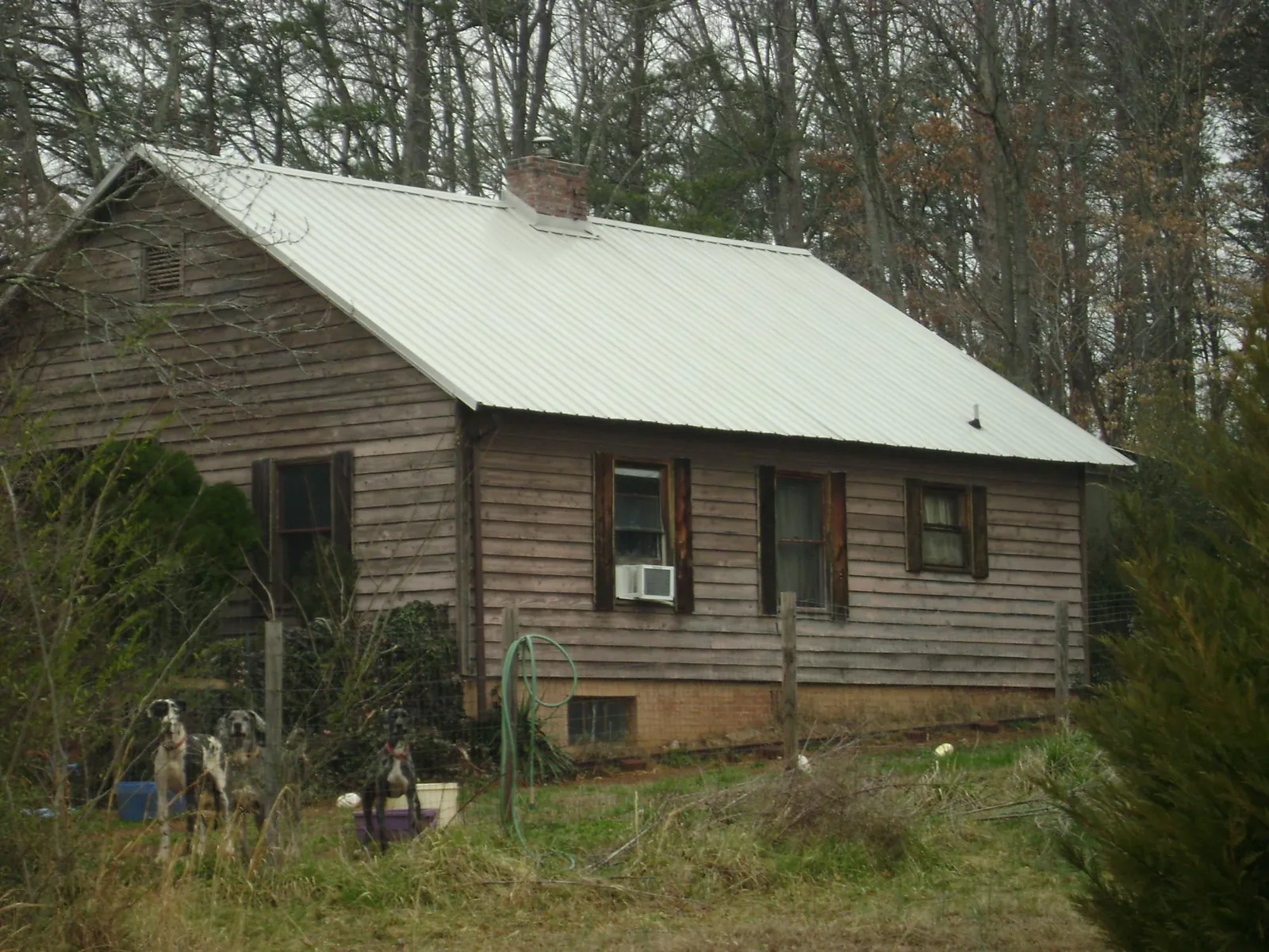 White metal roof on an old wood sided farmhouse, from a Metal Roof Installation job in La Belle
